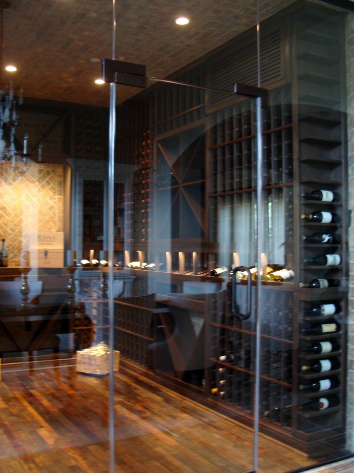 Seamless Glass Wine Cellar Door Provides a Clear View of the Wine Display in an Austin Home
