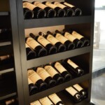 Reveal racks highlights the beautiful wine labels of the personal collection in the custom wine cellar.