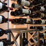 Triple-deep wine pegs maximizes the bottle capacity for the custom glass wine cellar.