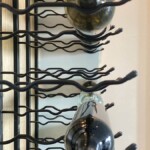 Label-forward metal racks are typical in modern glass wine cellars.