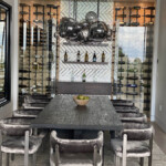 The metal wine racking is enhanced with a touch of class and refinement by the use of mirror tiles.