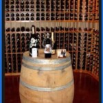 This is a reclaimed wine barrel repurposed to be a display table inside a home wine cellar.