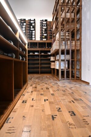 14 - Luxury wine cellar in Tarrytown, Austin featuring custom wine racks and wine barrel flooring for large collections. Custom Wine Racks in Tarrytown, Austin