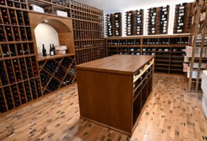 13 - Centerpiece Island Surrounded by Custom Wine Racks Wine cellar island with surrounding custom wine racks in Austin, TX.